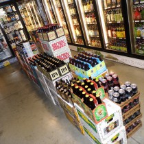 stacks of beers in the aisle in front of the beer coolers